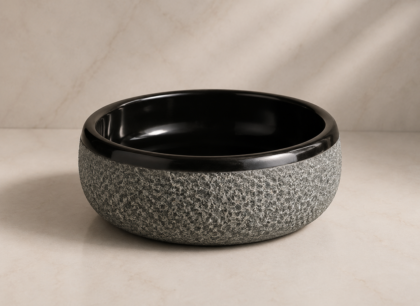 Designer black stone wash basin with textured exterior, polished finish, and modern luxury bathroom aesthetics by CAROLIETO.